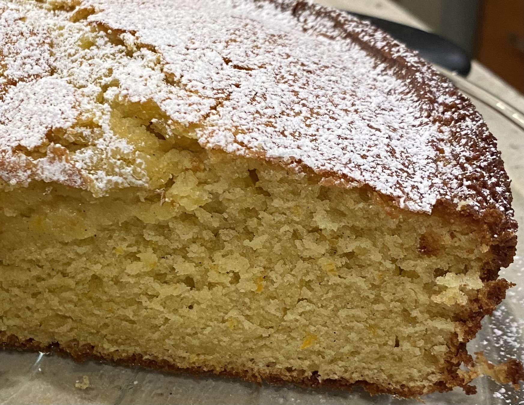 slicing into the finished cake