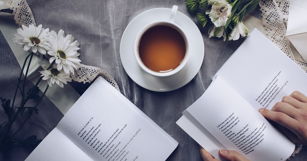 a cup of tea, some flowers, and books