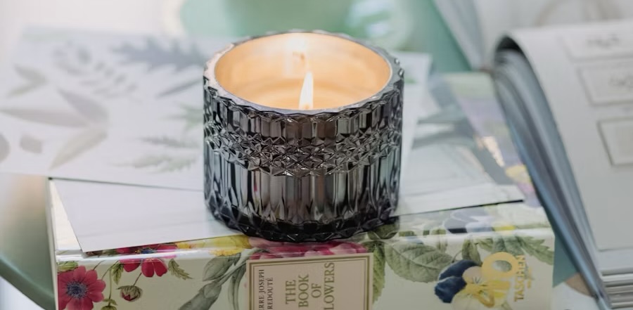 a candle and books on a desktop